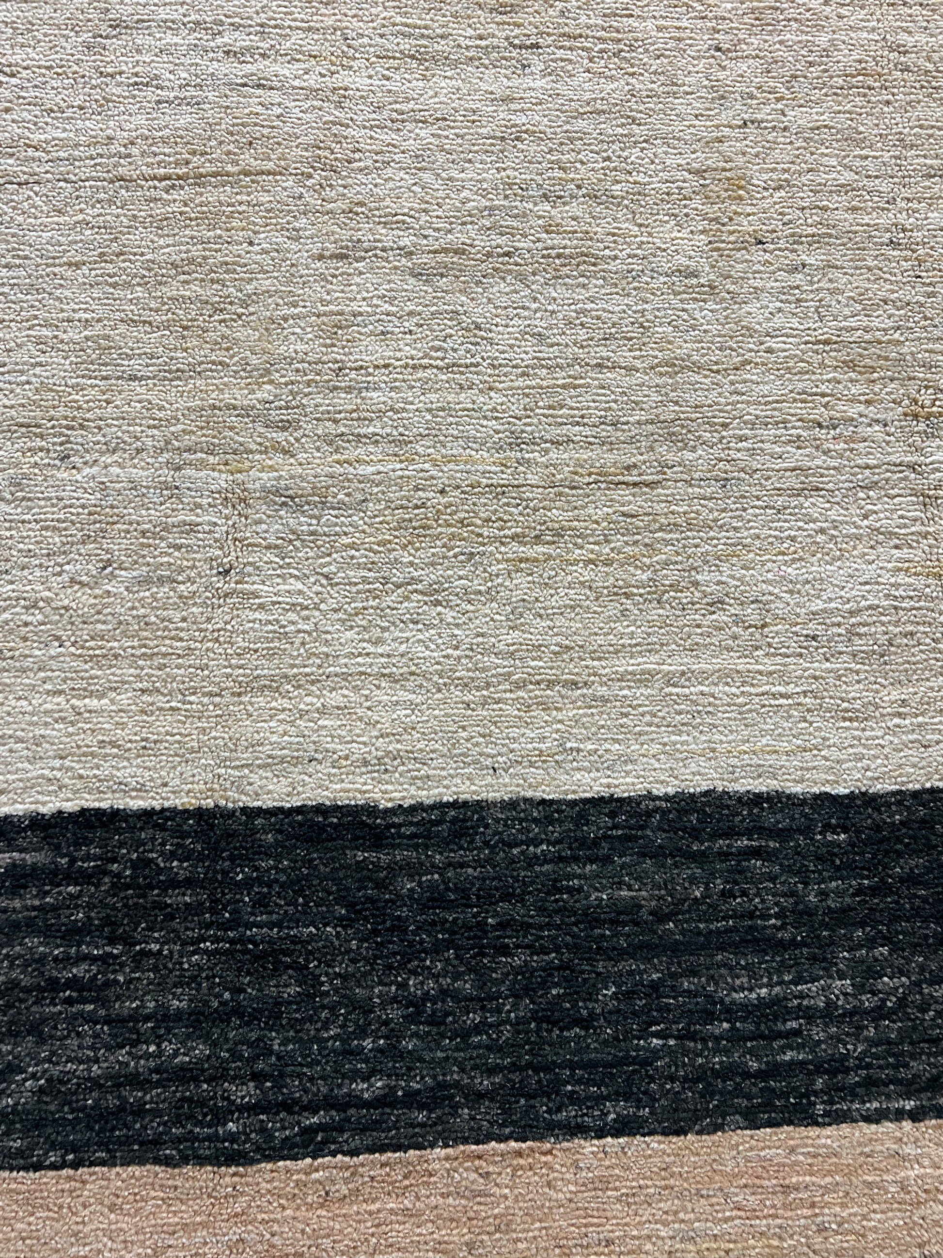 Contemporary wool rug close-up artisan craftsmanship handwoven texture detail

