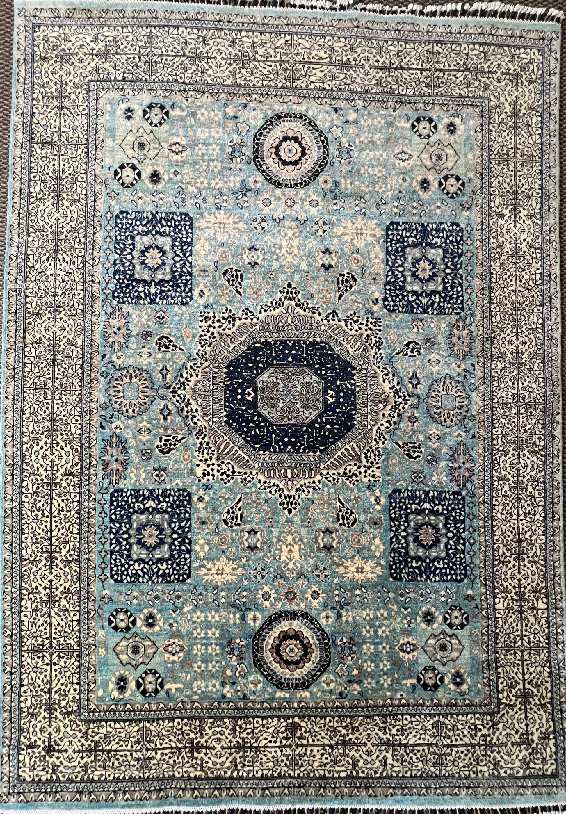 Mamluk hand-knotted rug detail - intricate geometric medallion and Afghan craftsmanship