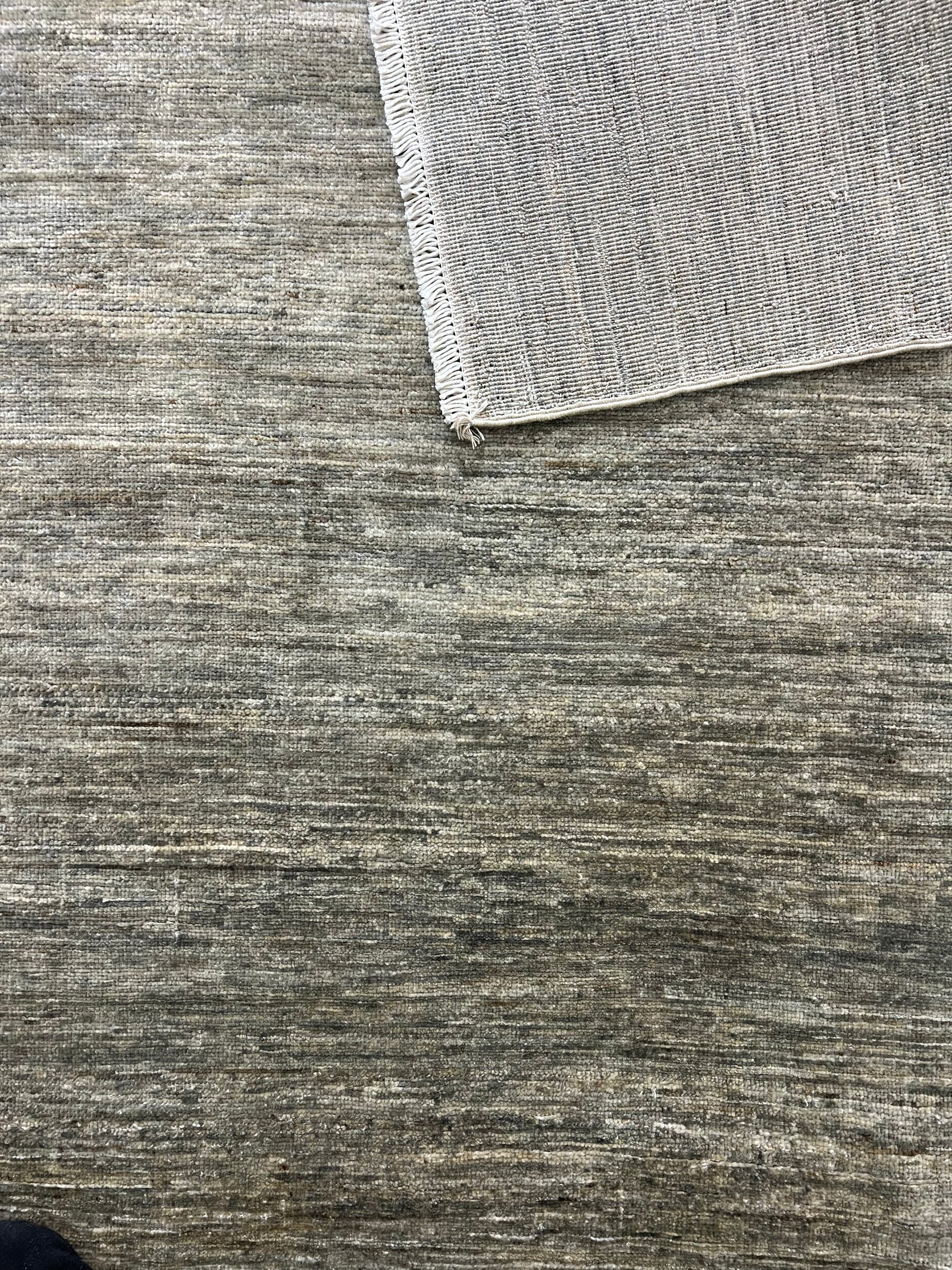 5.5′ × 5.5′ Gabbeh Rug – Hand-Knotted Wool | Persian-Inspired Artisan Craftsmanship | Luxury Tribal Contemporary Area Rug · Gabbeh wool rug shown at an angle to reveal colour and design.